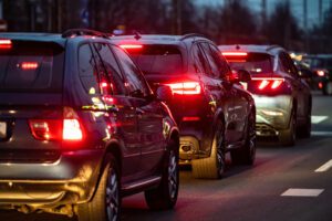 Riga, Latvia, November 2, 2021: peak hour, automobile brake lights at evening time, traffic jam on a highway street in city